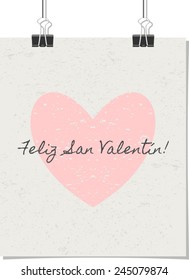 Vintage style poster for Valentine's Day with a pastel pink heart and text. "Feliz San Valentin!" - Spanish for "Happy Valentine's Day!". Poster design mock-up with paper clips, isolated on white.