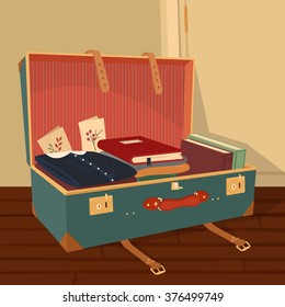 Vintage suitcase with clothes, books and postcards near the door