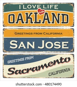 Vintage tin sign collection with USA cities. Oakland. San Jose. Sacramento. Retro souvenirs or postcard templates on rust background.