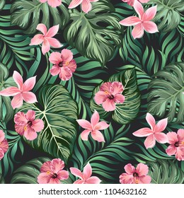 Vintage tropical background with palm leaves and flowers. Seamless vector background.