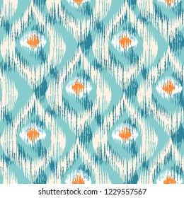 Padrão sem emenda de vetor vintage em estilo ikat. Padrão colorido ikat retrô com penas de pavão.