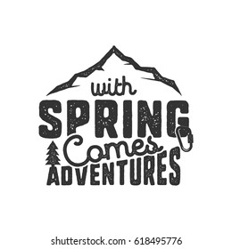 Vintage wanderlust hand drawn label design. "With Spring Comes Adventures" sign and outdoor activity symbols - mountains. Monochrome. Isolated on white background. Vector letterpress effect..