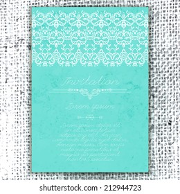 Vintage Wedding card or invitation with abstract lace decoration on a realistic burlap texture