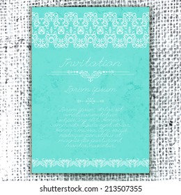 Vintage Wedding card or invitation with abstract lace decoration on a realistic burlap texture