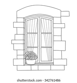Vintage window with blooming flowers in pot.