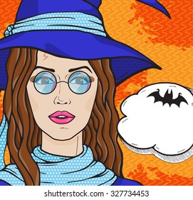 Vintage witch in hat and round glasses with speech bubble for your text. Girl in witch costume on orange background, pop art comic style vector illustration.