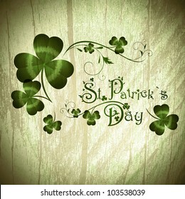 Vintage wooden background with St.Patrick day greeting with shamrocks