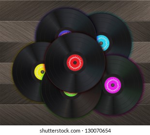 Vinyl Music Background with many vinyl disks in center of the image on a wood floor.