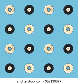 Vinyl music records and CD discs on light blue background. Vector seamless pattern