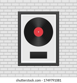 Vinyl record with black frame on white brick wall