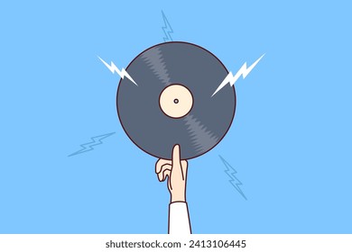 Vinyl record with retro music in hand of man offering to listen to classical composition or jazz concert from last century. Vinyl record for meloman enjoys collecting rare audio records