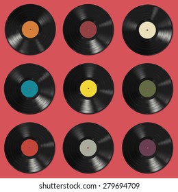 Vinyl records with colorful labels on pink background. Seamless pattern.