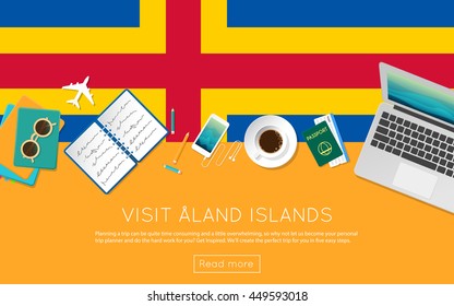 Visit Aland Islands concept for your web banner or print materials. Top view of a laptop, sunglasses and coffee cup on Aland Islands national flag. Flat style travel planninng website header.