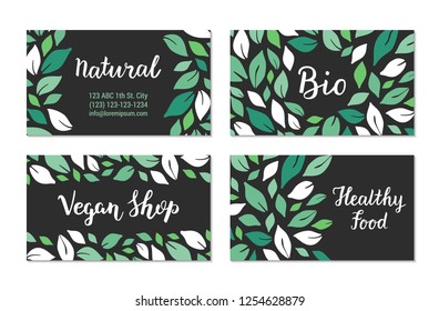 Visit cards with green salad leaves pattern on the black background. Natural, Bio, Vegan shop, Healthy food lettering text. Colourful template design. Plant-based concept. Vector EPS 10 illustration