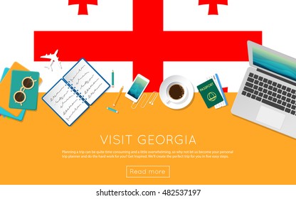 Visit Georgia concept for your web banner or print materials. Top view of a laptop, sunglasses and coffee cup on Georgia national flag. Flat style travel planninng website header.