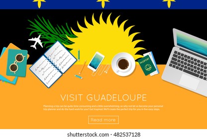 Visit Guadeloupe concept for your web banner or print materials. Top view of a laptop, sunglasses and coffee cup on Guadeloupe national flag. Flat style travel planninng website header.