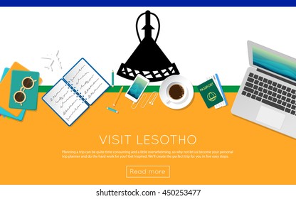 Visit Lesotho concept for your web banner or print materials. Top view of a laptop, sunglasses and coffee cup on Lesotho national flag. Flat style travel planninng website header.