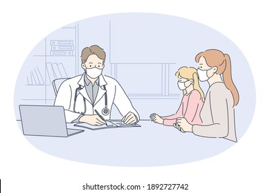 Visiting paediatrician during coronavirus pandemic concept. Mother with small daughter in face medical masks sitting and listening to recommendation of young man pediatrist in medical clinic office 