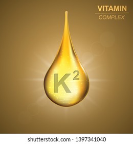 Vitamin k2 gold shining drop icon .Menaquinones Vitamin complex background