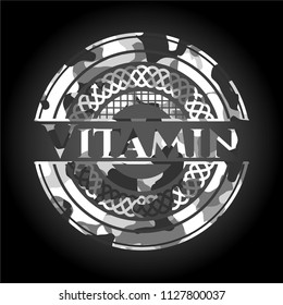 Vitamin on grey camouflage texture