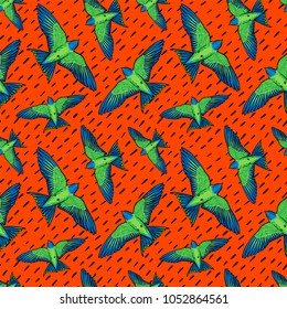 Vivid Birds seamless pattern. Colorful texture with green parrots on orange background. Tropic birds background for textile, fabric covers wallpapers print gift wraping Home decor. Vector illustration