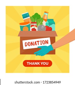 Volunteer holding a donation box with grocery food, solidarity and volunteering concept