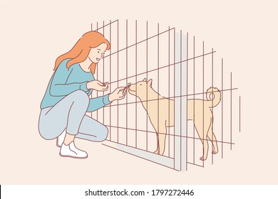 Volunteering, care, love, affection concept. Young happy smiling woman girl volunteer cartoon character feeding food dog pet friend in nursery. Adoption stray animal from special shelter illustration.