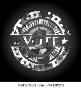 Vote written on a grey camouflage texture