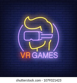 VR Games lettering and player in glasses neon sign on brick background. Augmented reality, videogame, club. Game concept. For topics like entertainment, leisure, technology