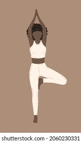 Vrikshasana, tree pose. Young slim woman doing yoga exercise