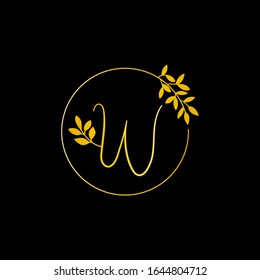 W Gold letter and Gold Leaf logo design. W Letter golden initial luxury Boutique Nature Floral Flower. W Monogram vector design concept and with leaf for fashion brand and luxuries business identity.