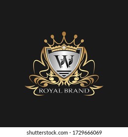 W Letter Gold Shield Logo. Elegant vector logo badge template with alphabet letter on shield frame ornate style design.
