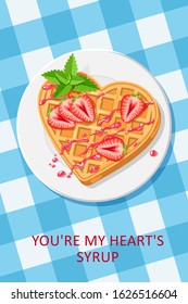 waffle in the shape of a heart with strawberries, mint and syrup on blue checkered tablecloth. valentine's day greeting card