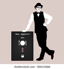 The waiter - actor in a black suit and a bowler hat next to the board for the menu