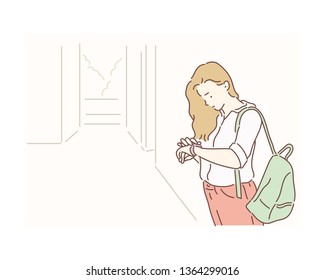 Waiting girl looks at the wrist watch. Hand drawn style vector design illustrations.