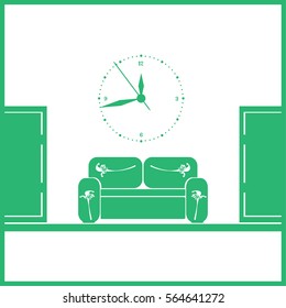 waiting room sofa in front of the door and a clock on the wall 