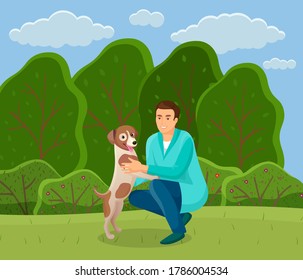 Walk with dog in the park. Man is sitting and playing with a pet in summer garden. A happy doggy plays with the owner against the backdrop of a spring landscape with a green meadow and high trees