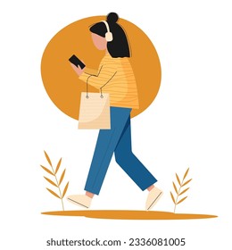 Walking girl in headphones and with a phone and shopping
