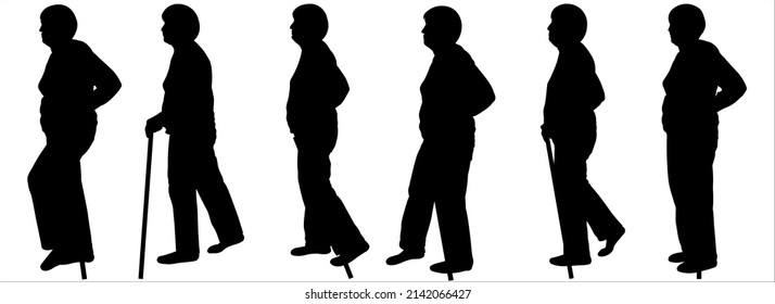 Walking With A Walking Stick. Disabled Person. An Older Woman With A Walking Stick In Her Hand. An Elderly Woman Walks With A Cane In Her Hand. Women Walk One After Another In One Line. Black Shadows.