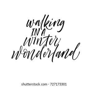 Walking in a winter wonderland phrase. Greeting card. Winter lettering. Ink illustration. Modern brush calligraphy. Isolated on white background.