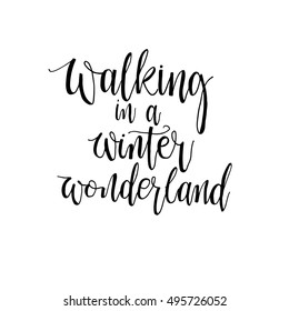 Walking in a winter wonderland phrase for poster  or design for  cups, t-shirt, vector illustration. Modern brush calligraphy. Isolated on white background.