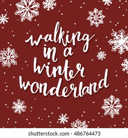 Walking in a winter wonderland. Quote about winter holiday season. Modern calligraphy phrase with hand drawn snowflakes. Lettering for christmas greeting cards and posters