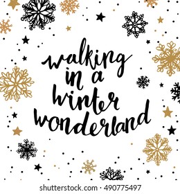 Walking in a winter wonderland. Quote about winter holiday season. Modern calligraphy phrase with hand drawn snowflakes. Lettering for christmas greeting cards and posters
