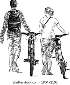 walking young people with bicycles