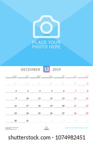 Wall calendar for December 2019. Vector design print template with place for photo. Week starts on Monday. Portrait orientation