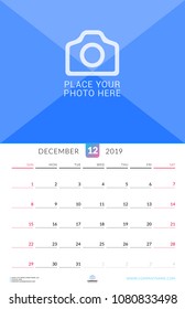 Wall calendar for December 2019. Vector design print template with place for photo. Week starts on Sunday. Portrait orientation