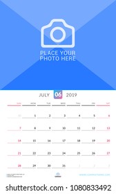 Wall calendar for July 2019. Vector design print template with place for photo. Week starts on Sunday. Portrait orientation