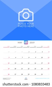 Wall calendar for May 2019. Vector design print template with place for photo. Week starts on Sunday. Portrait orientation