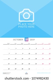Wall calendar for October 2019. Vector design print template with place for photo. Week starts on Monday. Portrait orientation