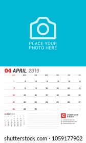 Wall calendar planner for 2019 year. April. Vector print template with place for photo. Week starts on Sunday